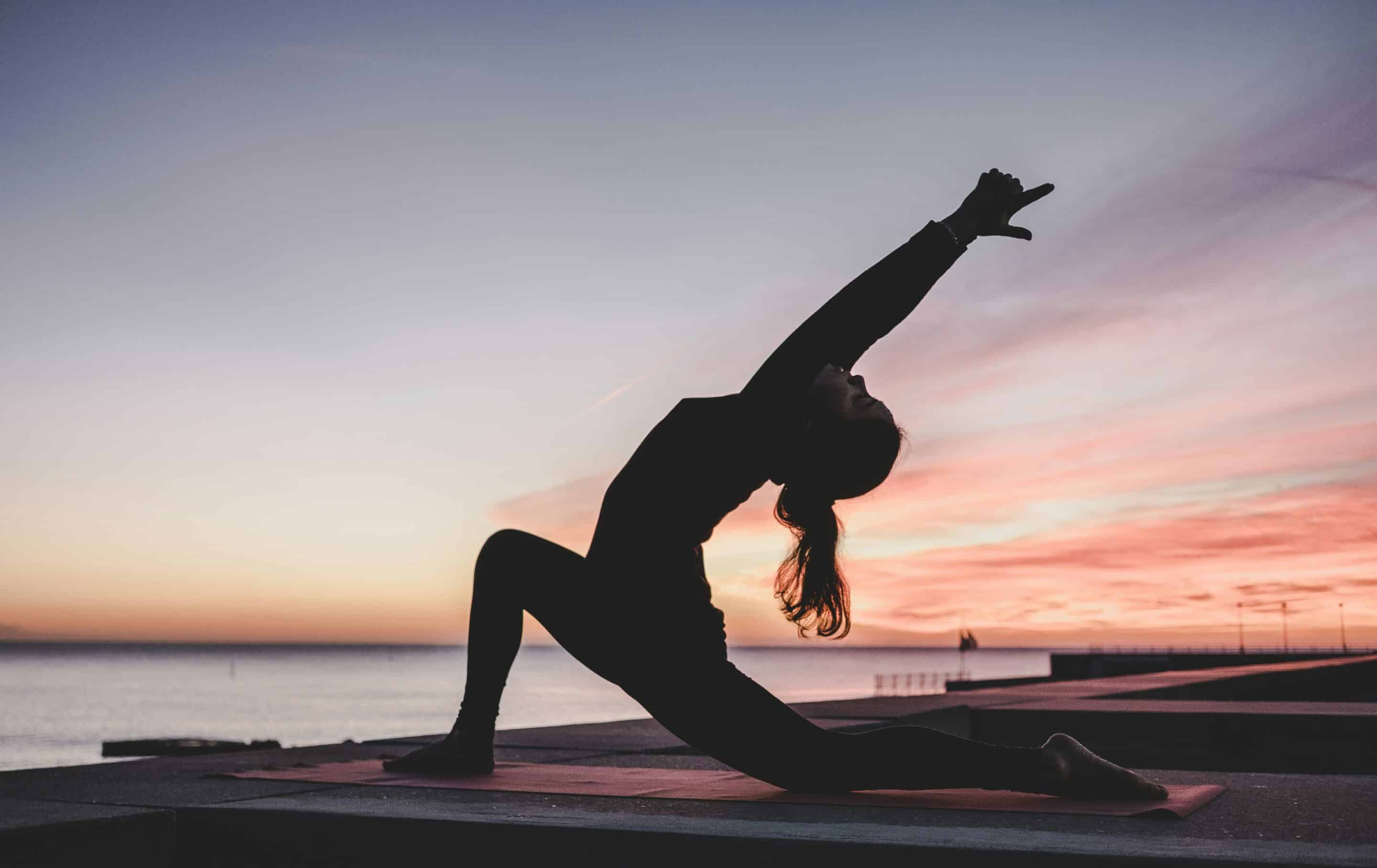 A woman stretching in the early morning.